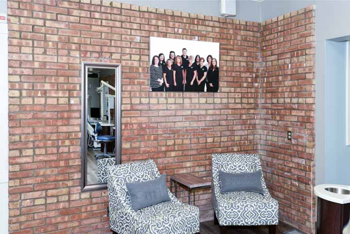 our staff photo on warm brick wall